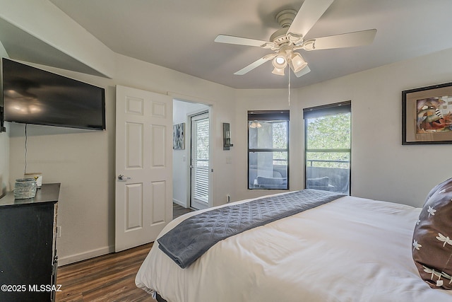 bedroom featuring baseboards, ceiling fan, and dark wood-type flooring