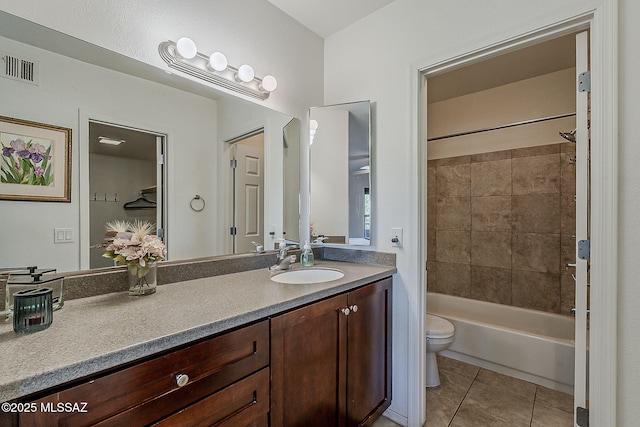 bathroom featuring visible vents, tile patterned floors, vanity, toilet, and shower / bathtub combination