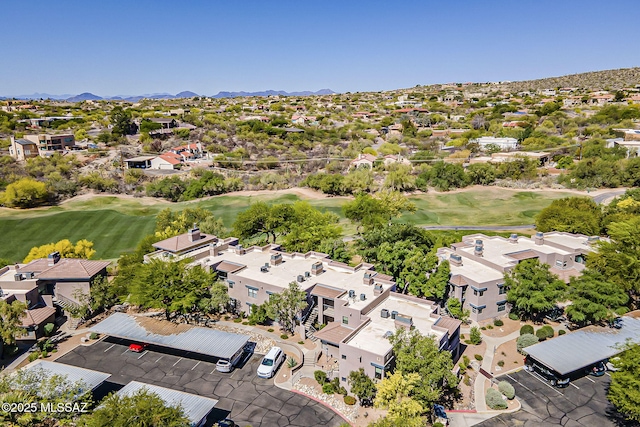 birds eye view of property featuring view of golf course, a mountain view, and a residential view