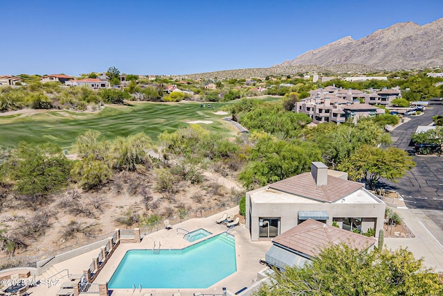 aerial view featuring view of golf course and a mountain view