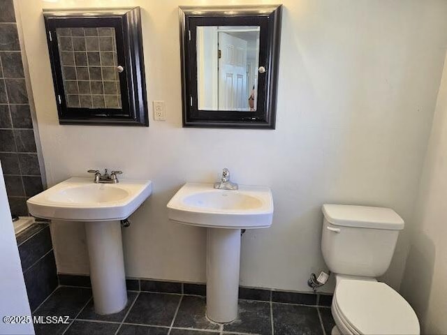 4743 E Scarlett St, Tucson, AZ 85711 - bathroom with toilet and tile patterned floors
