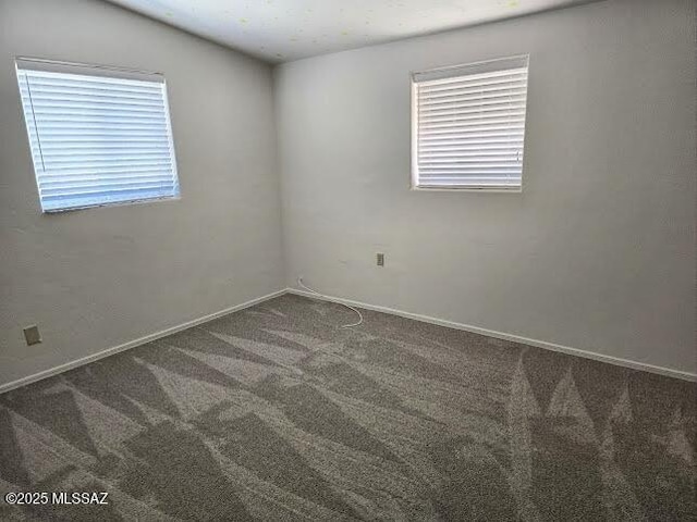 4743 E Scarlett St, Tucson, AZ 85711 - empty room with carpet floors and baseboards