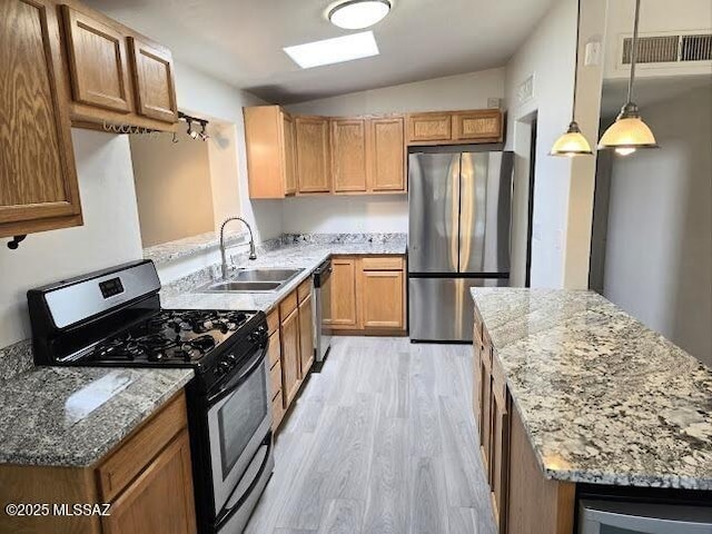 4743 E Scarlett St, Tucson, AZ 85711 - kitchen featuring lofted ceiling, a sink, appliances with stainless steel finishes, visible vents, and light wood finished floors