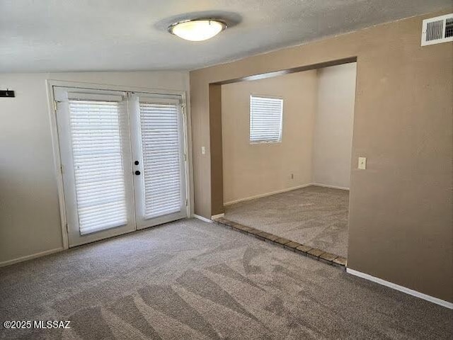 4743 E Scarlett St, Tucson, AZ 85711 - spare room featuring carpet, visible vents, french doors, and baseboards