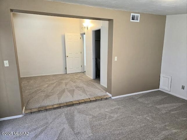 4743 E Scarlett St, Tucson, AZ 85711 - carpeted spare room featuring baseboards and visible vents
