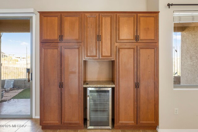 interior details featuring a bar and beverage cooler