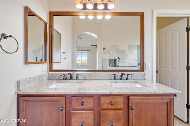 bathroom with a sink and double vanity