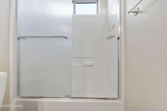 bathroom with an enclosed shower and toilet