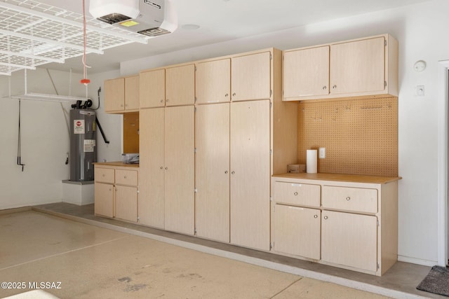 garage featuring a garage door opener and electric water heater