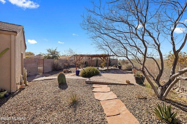 view of yard featuring a pergola, a gate, a fenced backyard, and a patio area