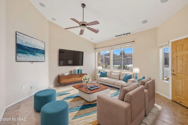 living area featuring tile patterned flooring, ceiling fan, baseboards, and vaulted ceiling
