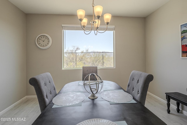5369 S Sierra Prieta Trl, Tucson, AZ 85747 - dining area with a healthy amount of sunlight, baseboards, wood finished floors, and an inviting chandelier
