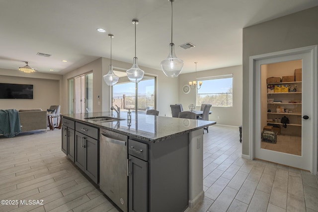 5369 S Sierra Prieta Trl, Tucson, AZ 85747 - kitchen with stainless steel dishwasher, visible vents, open floor plan, and dark stone counters