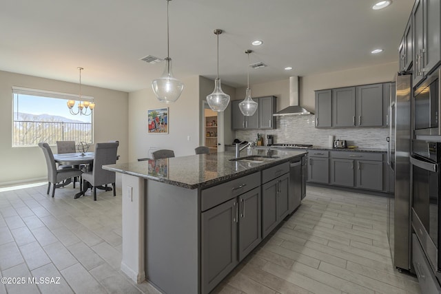 5369 S Sierra Prieta Trl, Tucson, AZ 85747 - kitchen with a sink, gray cabinets, wall chimney range hood, and tasteful backsplash