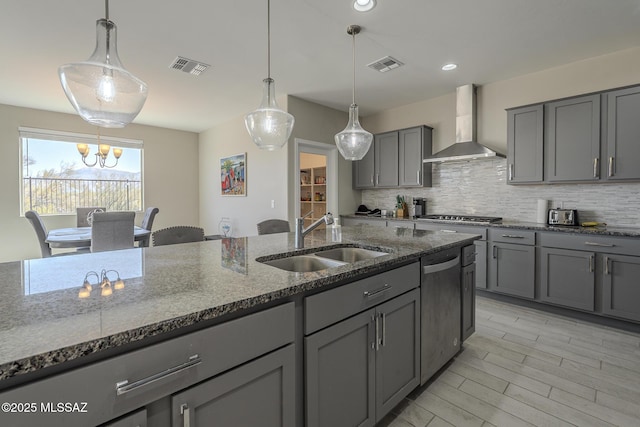 5369 S Sierra Prieta Trl, Tucson, AZ 85747 - kitchen featuring wall chimney range hood, a sink, gray cabinets, appliances with stainless steel finishes, and visible vents