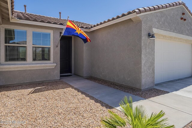 5369 S Sierra Prieta Trl, Tucson, AZ 85747 - property entrance featuring stucco siding, an attached garage, and a tiled roof