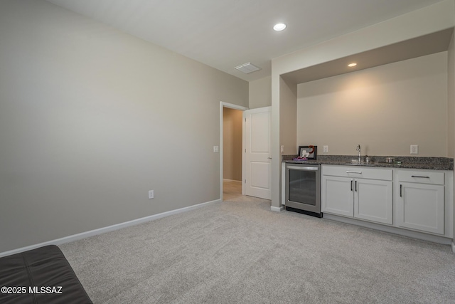 5369 S Sierra Prieta Trl, Tucson, AZ 85747 - bar with baseboards, beverage cooler, light colored carpet, wet bar, and visible vents
