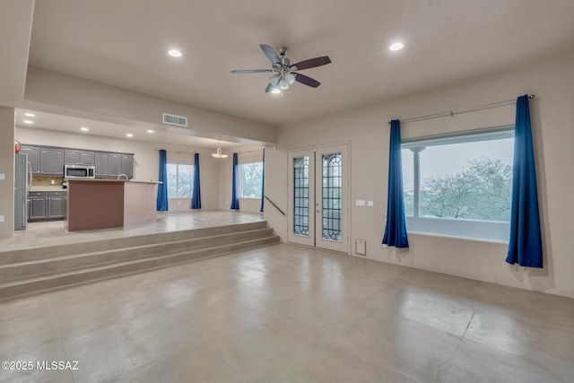 unfurnished living room featuring visible vents, a ceiling fan, and recessed lighting
