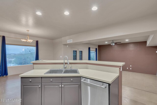kitchen with visible vents, open floor plan, a sink, dishwasher, and gray cabinetry