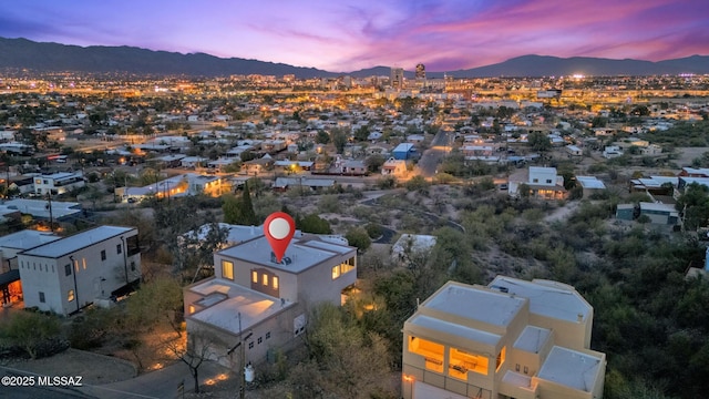 aerial view at dusk featuring a mountain view