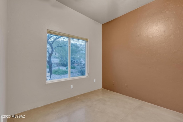 tiled empty room with a textured wall