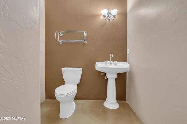 bathroom featuring toilet and tile patterned flooring