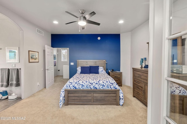 bedroom featuring carpet flooring, recessed lighting, arched walkways, and visible vents