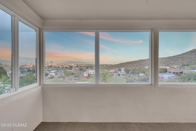 unfurnished sunroom featuring a mountain view