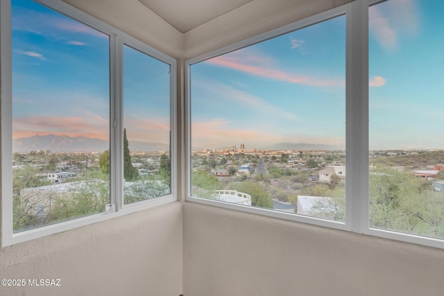unfurnished sunroom with a mountain view