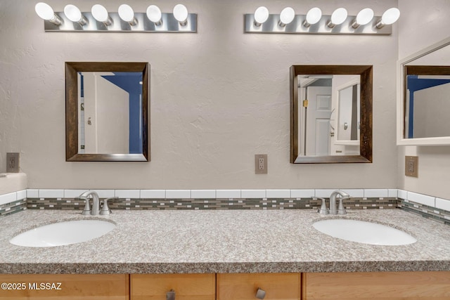 bathroom featuring double vanity and a sink