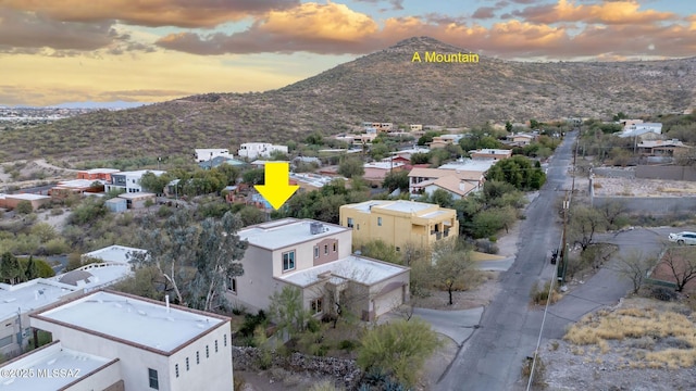 aerial view at dusk with a mountain view and a residential view