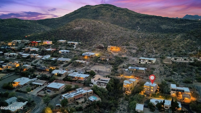 aerial view at dusk featuring a mountain view