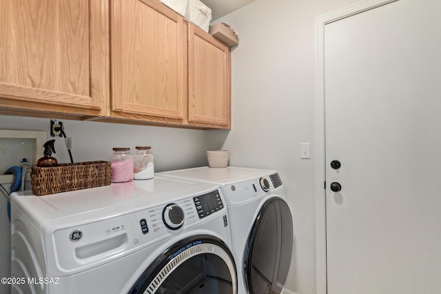 laundry area with cabinet space and washing machine and clothes dryer