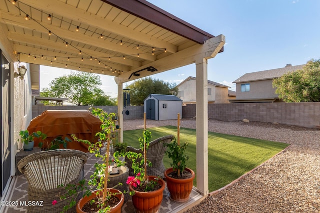 view of yard featuring a storage shed, an outbuilding, and a fenced backyard