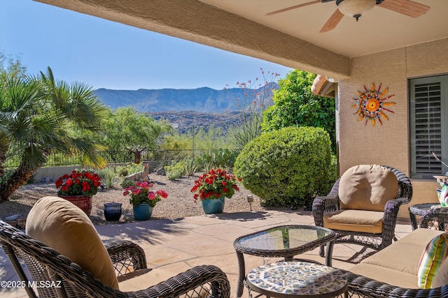 37561 S Desert Sun Dr, Saddlebrooke, AZ 85739 - view of patio / terrace featuring a mountain view, ceiling fan, and fence