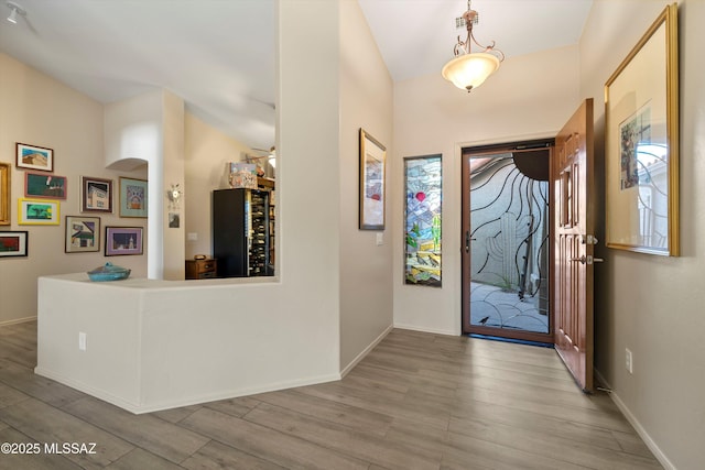37561 S Desert Sun Dr, Saddlebrooke, AZ 85739 - foyer featuring wood finished floors, baseboards, and arched walkways