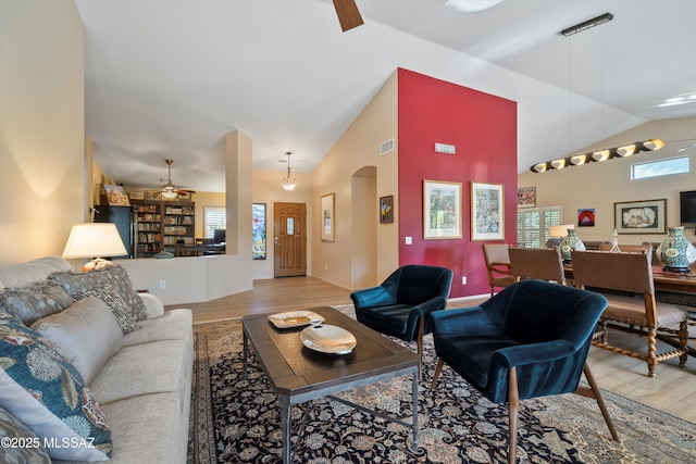37561 S Desert Sun Dr, Saddlebrooke, AZ 85739 - living area featuring lofted ceiling, light wood-style flooring, ceiling fan, visible vents, and arched walkways