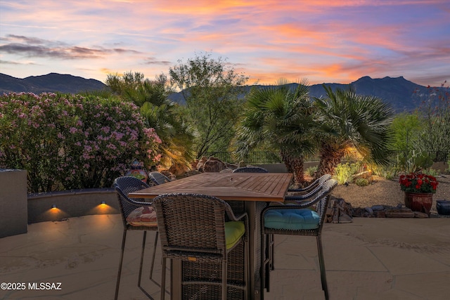 37561 S Desert Sun Dr, Saddlebrooke, AZ 85739 - patio terrace at dusk with a mountain view and outdoor dining area
