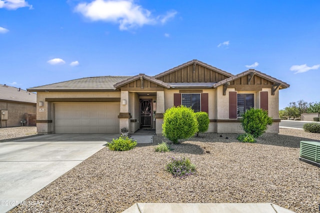 view of front of property with a garage, stucco siding, a tile roof, and concrete driveway