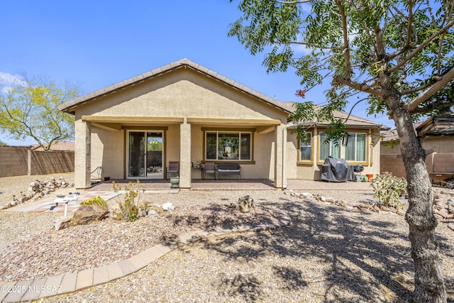 back of house with stucco siding and fence private yard