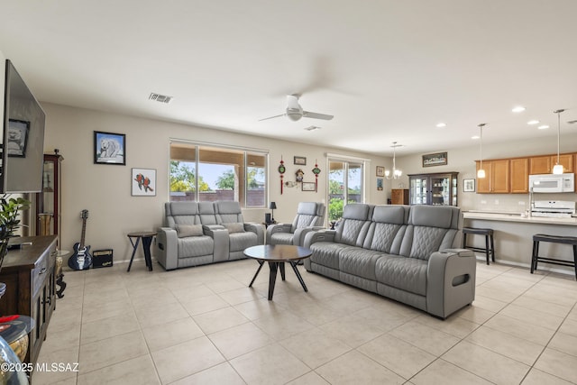 living area featuring recessed lighting, light tile patterned flooring, visible vents, and a ceiling fan