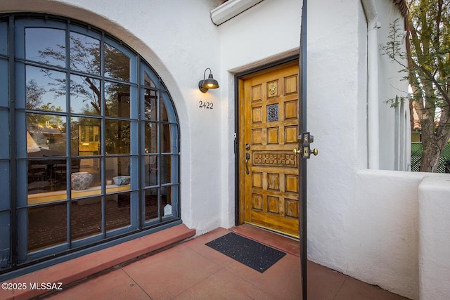 doorway to property with stucco siding