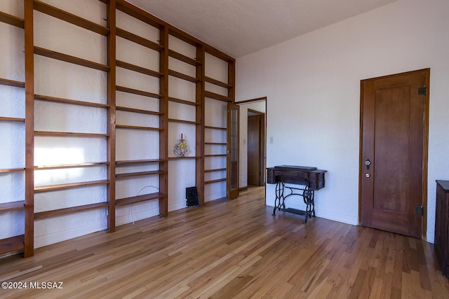 interior space with built in features, baseboards, and wood finished floors