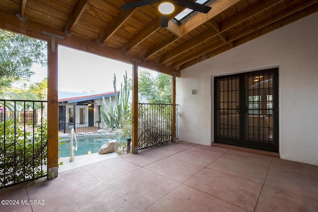 exterior space featuring a ceiling fan, an outdoor pool, fence, and french doors
