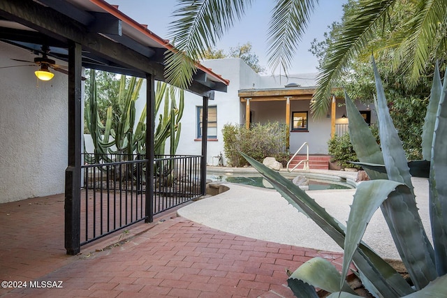 view of patio / terrace with a ceiling fan and an outdoor pool