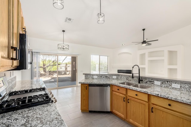 kitchen with lofted ceiling, stainless steel dishwasher, a sink, ceiling fan, and gas stove