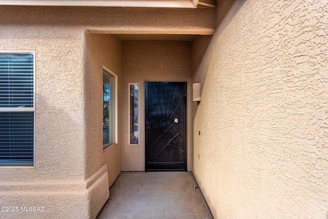 property entrance featuring stucco siding