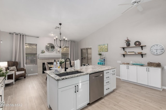 5305 N Via Ln, Doncella, Tucson, AZ 85750 - kitchen featuring stainless steel dishwasher, a sink, light wood-style flooring, white cabinets, and vaulted ceiling