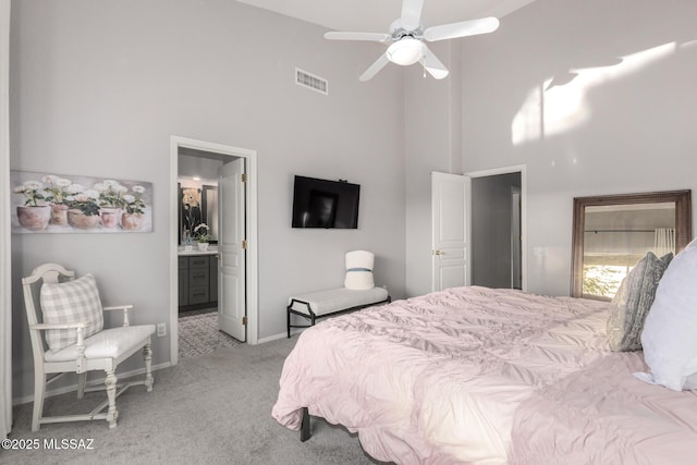 5305 N Via Ln, Doncella, Tucson, AZ 85750 - bedroom featuring a high ceiling, light colored carpet, baseboards, ensuite bath, and a ceiling fan