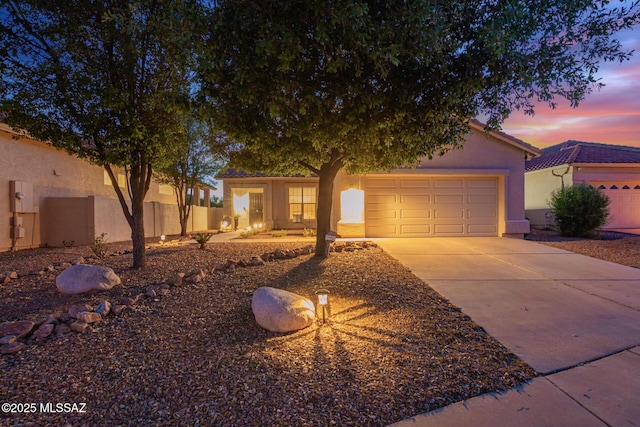 5305 N Via Ln, Doncella, Tucson, AZ 85750 - view of front of house featuring concrete driveway, stucco siding, an attached garage, and fence